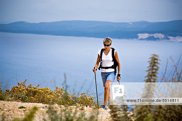 Woman hiking at the seaside  Omis  Adriatic coast  Croatia  Europe
