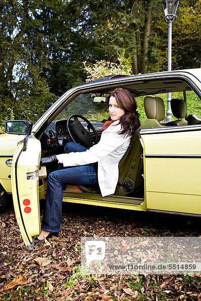 Young woman in a post-war classic car