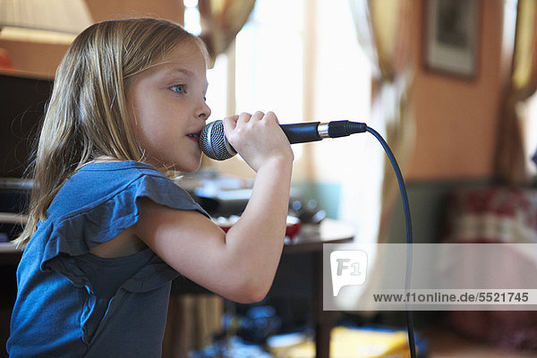 Girl singing into microphone