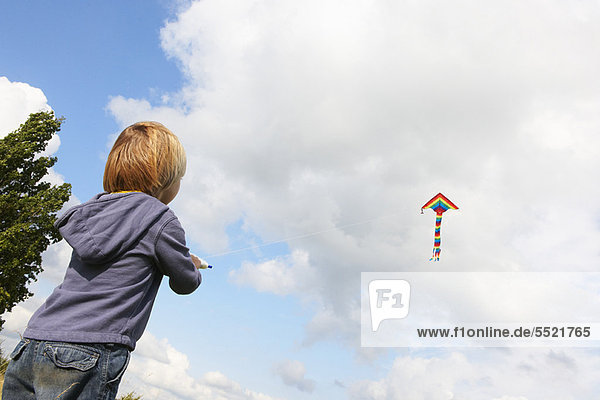 Boy flying kite outdoors