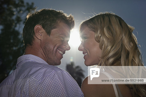 Couple smiling at each other outdoors