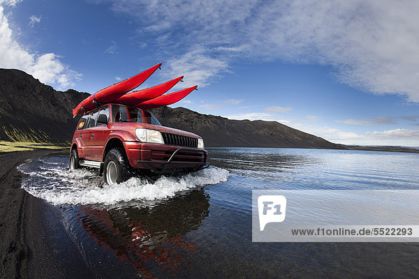 Jeep driving in shallow lake