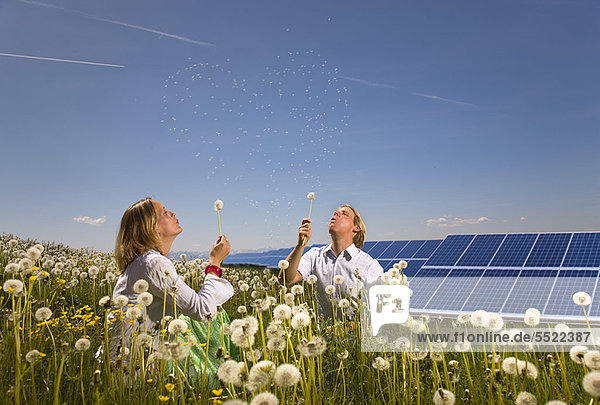 Couple in field with solar panels
