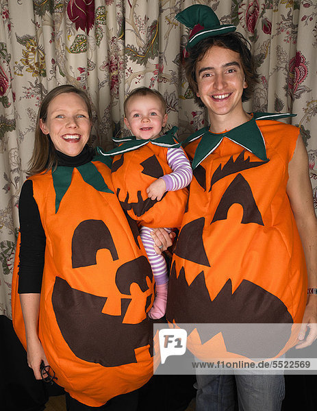 Family dressed as pumpkins for Halloween