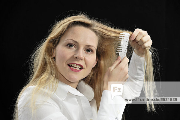 Junge Frau bürstet ihre Haare
