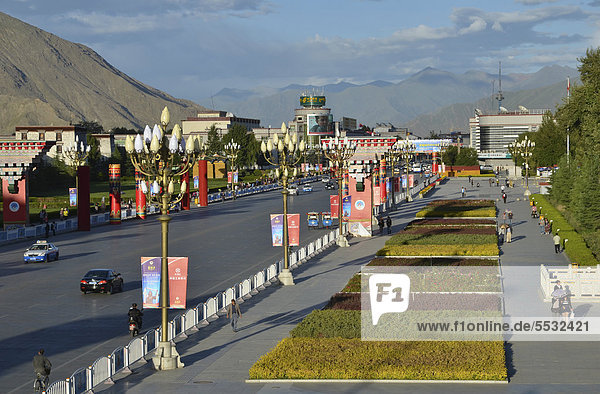 Road from the Potala Palace  winter palace of the Dalai Llama  towards the remaining Tibetan town and post office in Lhasa  Tibet  China  Asia