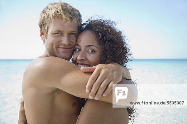 Couple embracing at the beach  portrait