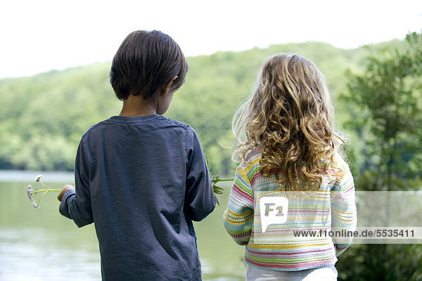 Children looking at lake view