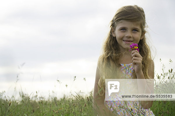 Girl holding bouquet of wildflowers  portrait