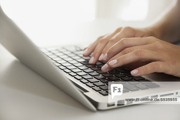 Woman's hands typing on laptop computer