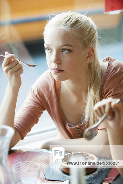 Young woman eating dessert