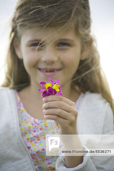 Girl holding wildflowers  portrait