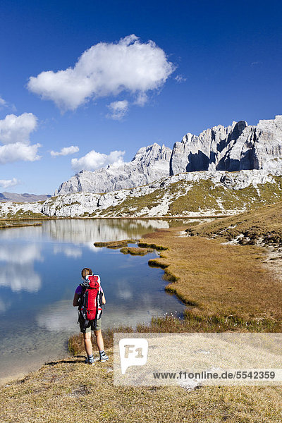 Hiker at the Boedenseen lakes  Einser Mountain on the right  Croda Rossa di Sesto Mountain at the rear  Sesto  Alta Pusteria  Dolomites  Alto Adige  Italy  Europe