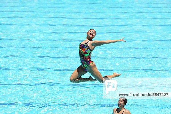 Swimmers Performing  Synchronized Swimming