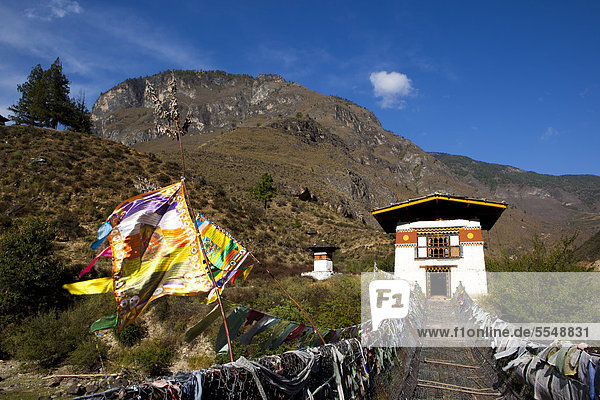 Haus mit Brücke und Gebetsfahnen  Bhutan