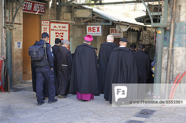 Patriarchy being escorted by soldiers during the sunday procession from the Latin Patriarchate Church through a street with a bazaar to the Church of the Holy Sepulchre in the Old City of Jerusalem  Israel  Middle East
