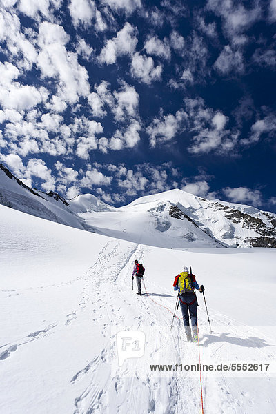 Climbers ascending Piz Palu through the glacier landscape  behind the summit of Piz Palu  Grisons  Switzerland  Europe