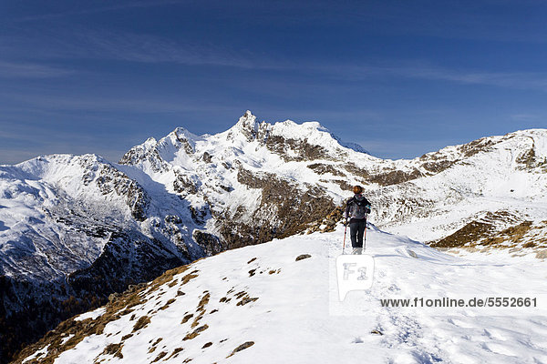 Hiker ascending Penser Weisshorn Mountain above Penser Joch Pass  summit of Penser Weisshorn Mountain at the rear  Sarn Valley  Alto Adige  Italy  Europe