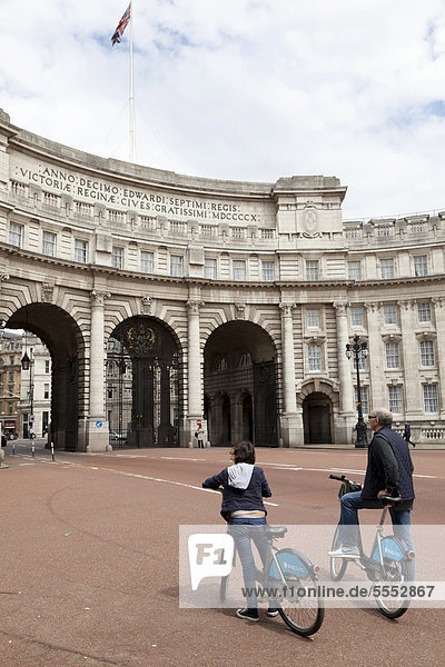 Two cyclists on Barclays Cycle Hire scheme at Admiralty Arch  London  England  United Kingdom  Europe