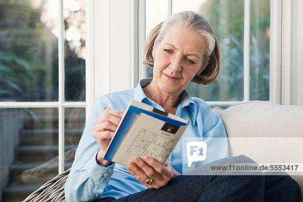 Senior woman doing sudoku puzzles