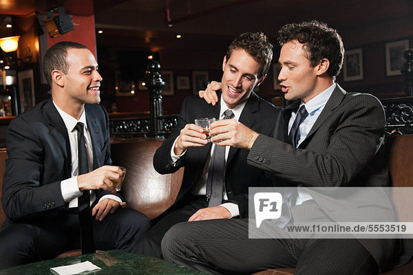 Businessmen drinking together in bar