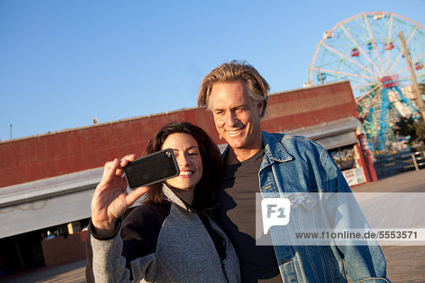 Couple at promenade taking a picture of themselves