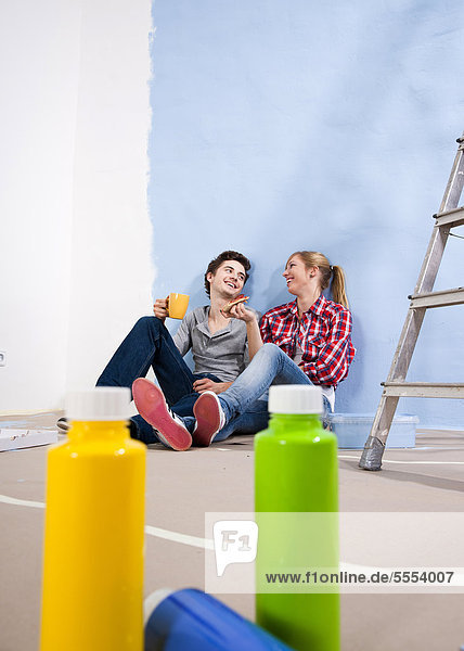 Young couple taking a break from renovating