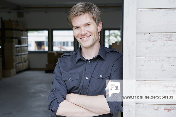 Smiling man standing in garage