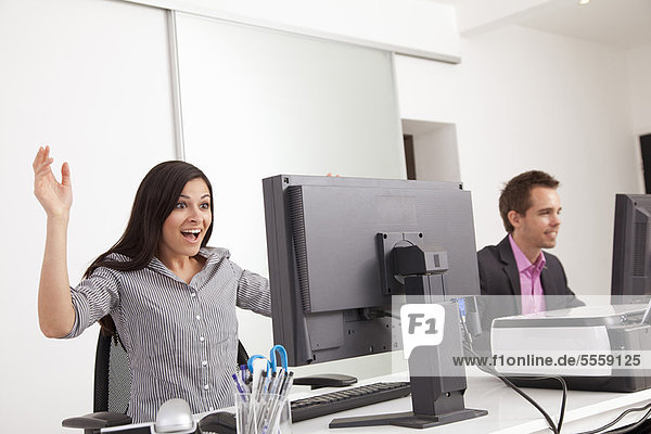Businesswoman gasping at desk