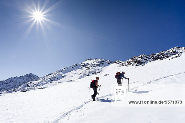 Hikers on Weissbrunnferner Mountain while ascending Hintere Eggenspitze Mountain in the Ulten Valley with the summit of Hintere Eggenspitze Mountain at the rear  Alto Adige  Italy  Europe