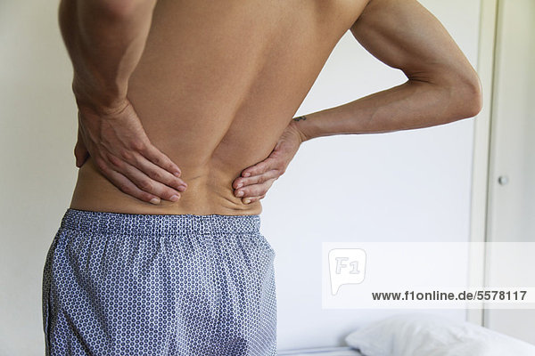 Man experiencing lower back pain  cropped