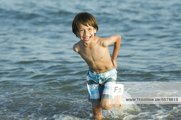 Boy playing in water at the beach