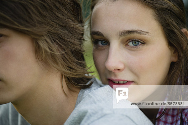 Young woman resting head on boyfriend's shoulder  cropped portrait