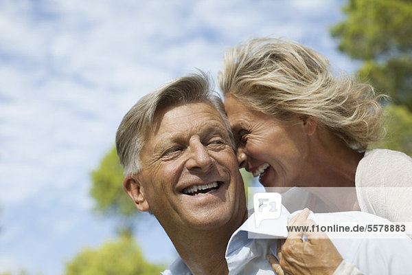Mature couple nuzzling outdoors  portrait