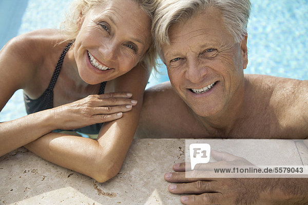 Mature couple relaxing together in pool  portrait