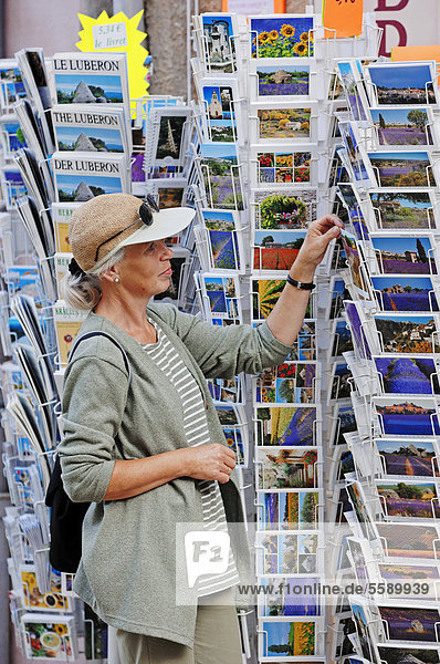 Woman looking at postcards outside a souvenir shop  Sault  Vaucluse  Provence-Alpes-Cote d'Azur  Southern France  France  Europe  PublicGround