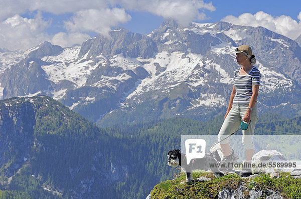 Woman with a Miniature Schnauzer  black and silver  on the summit of Jenner Mountain  Berchtesgaden National Park  Berchtesgadener Land  Bavaria  Germany  Europe  PublicGround