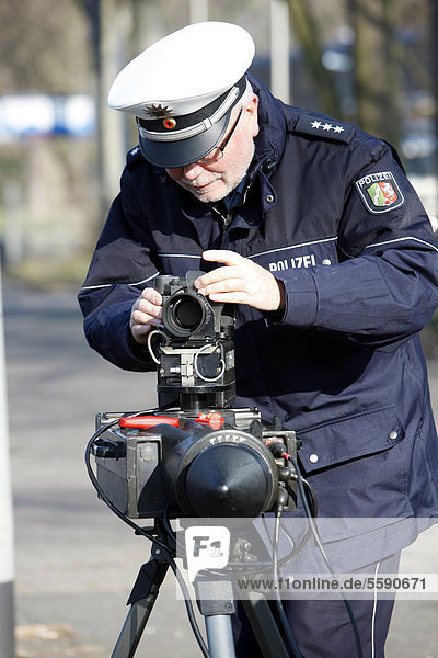 Police officer preparing a radar speed control camera  photocall  speed check marathon of the police in North Rhine-Westphalia on 10 February 2012  start of a long-term campaign against speeding in North Rhine-Westphalia  Germany  Europe