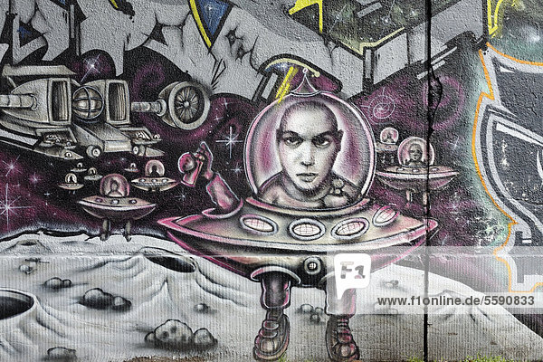 Graffiti man in a flying saucer with a glass dome on the moon Bruckhausen quarter Duisburg North Rhine-Westphalia Germany Europe