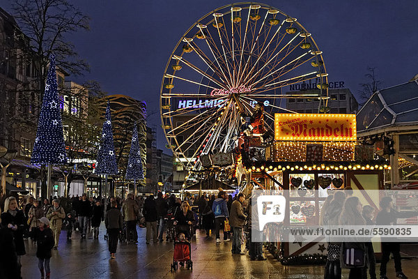 Christmas market with a ferris wheel at night Koenigsstrasse street Duisburg North Rhine-Westphalia Germany Europe