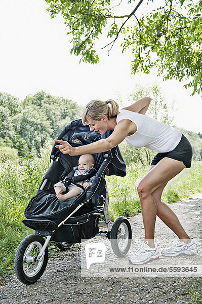 Mother with baby boy for jogging  smiling