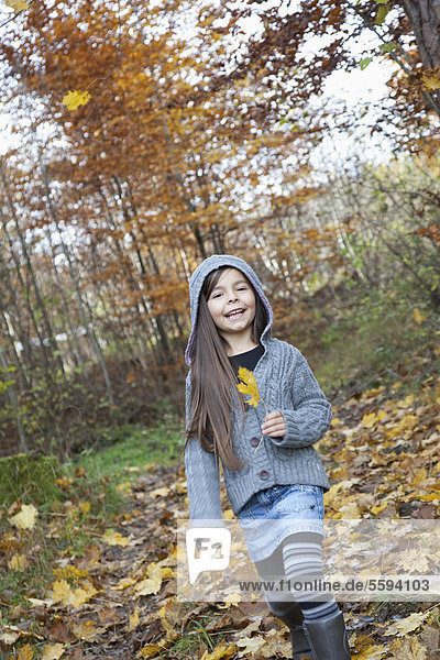 Girl holding leaf  smiling  portrait