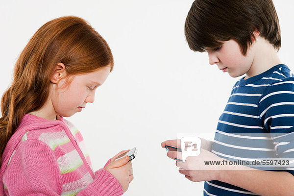 Boy and girl looking at smartphones