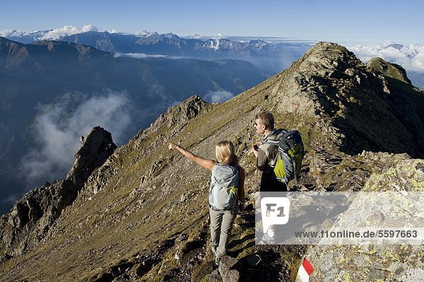Hiker using GPS  Dolomites  South Tyrol  Italy