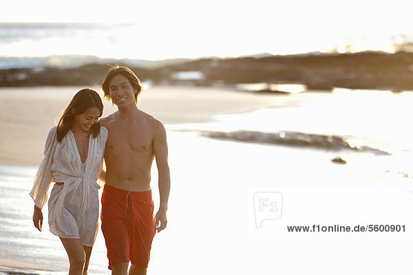 Couple walking together on beach
