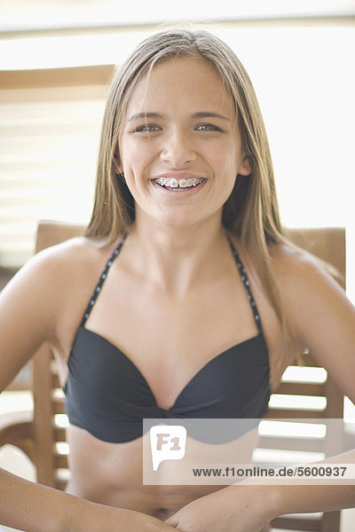 Teenage girl with braces wearing bikini