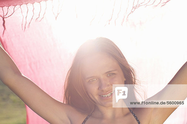 Teenage girl in braces holding sarong
