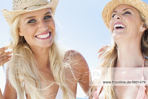 Women laughing together on beach
