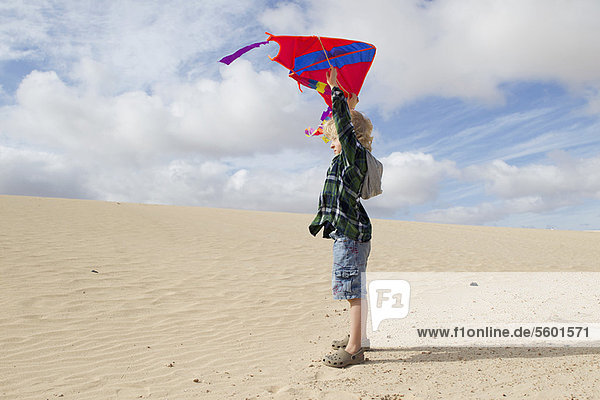Boy flying kite on beach