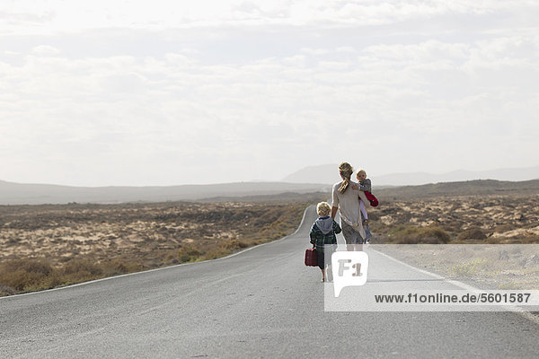 Mother and children on rural road